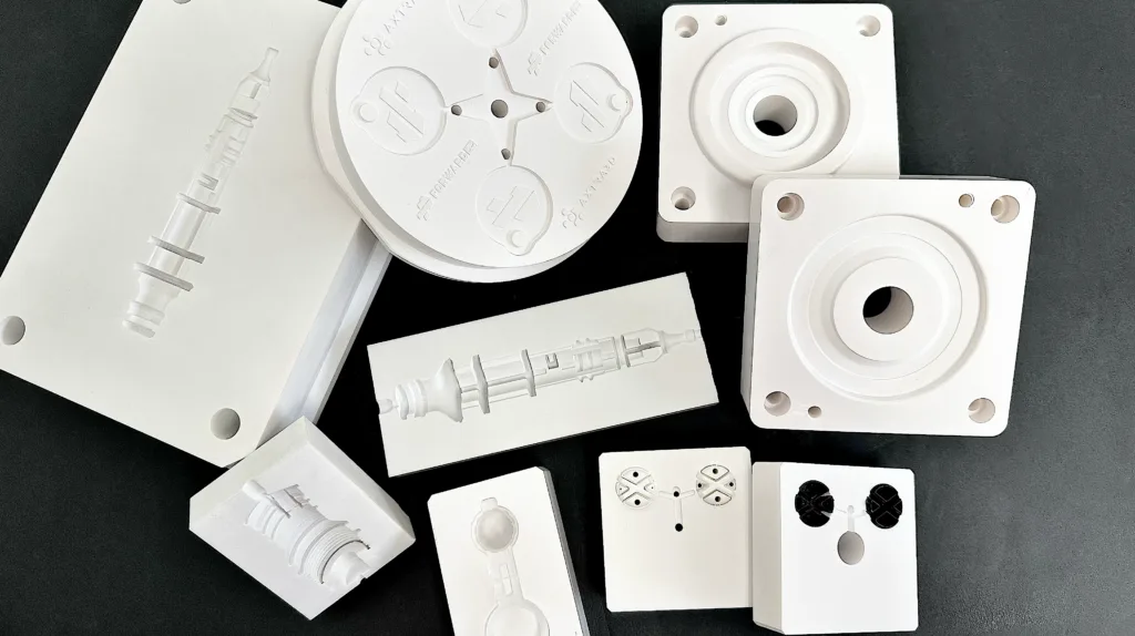 Resin-printed example parts from the Axtra3D workflow announcement.